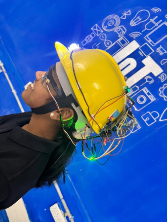 a person with a mining helmet on. the helmet is covered in circuits and wires