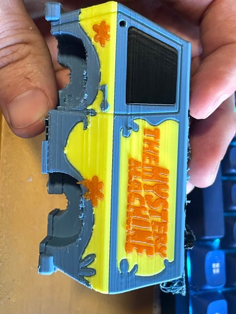 A 3D printed model of the Mystery Machine van. The different colored panels are done in one print. Seams between colors have a little extra material but no gaps or misalignment.