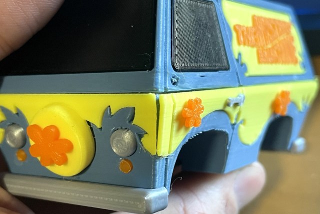 A 3D printed model of the Mystery Machine van. The different colored panels are separate prints, and there's a visible gap between them.